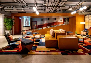 A contemporary, modern office space with a mix of materials and bright colors.