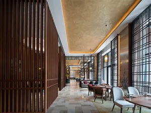 Modern restaurant interior featuring a combination of wooden slatted walls and stone-tiled floors.