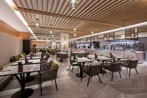 Contemporary restaurant interior with marble finishes and modern seating arrangements.