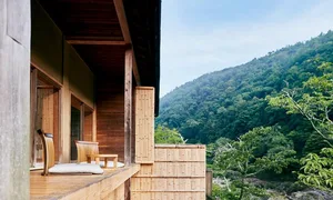A modern residence with wooden exterior and natural surroundings.