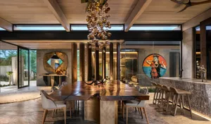 Modern dining room featuring wood and concrete elements.