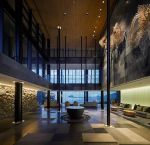 A modern, contemporary lobby with metallic and stone features.