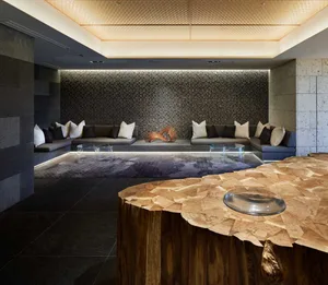 Modern hotel lobby with concrete walls, industrial design elements, and natural light.