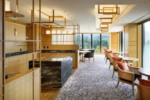 Hotel suite with modern interior design featuring wood and marble elements.