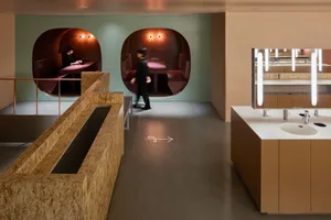 A modern industrial office space with concrete, wood, and glass elements.