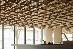 Modern office space with a wooden grid ceiling design.