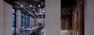 A stylish industrial-style restaurant interior featuring wood, concrete, and glass materials.