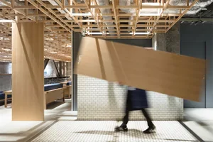 A blurred image of a retail space with an industrial design featuring wooden elements.