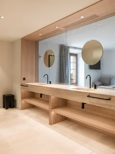 Modern bathroom with concrete countertop and wooden shelves.