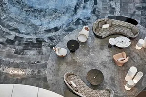 A modern marble lobby featuring elegant seating arrangements and luxurious decor.