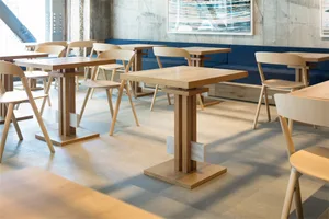 Modern restaurant interior design with wooden furniture and blue seating.