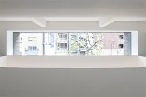 Concrete floor and plaster ceiling with a window view of a cityscape.