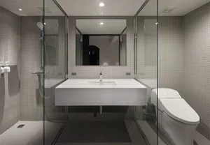 A modern bathroom with minimalist design and ceramic tile walls and floor.