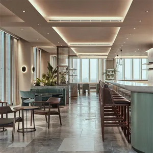 A modern cafe bar interior with concrete flooring, a bar counter, and seating.