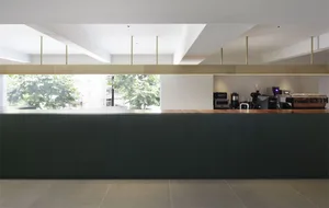 A modern cafe interior with a wooden counter and minimalistic design.