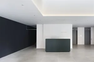 Modern hotel lobby featuring sleek black and white design elements.