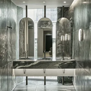 A modern marble bathroom with sleek, curved mirrors and elegant fixtures.