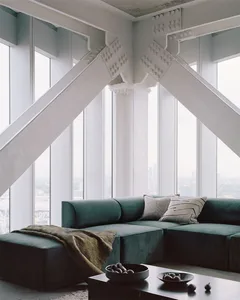 Modern minimalistic living room interior with a large, comfortable concrete couch accompanied by sleek, minimalist furnishing