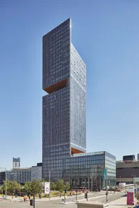 A modern office building with glass exterior in a cityscape