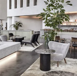 A modern restaurant interior with concrete, marble, and wooden elements and green plants