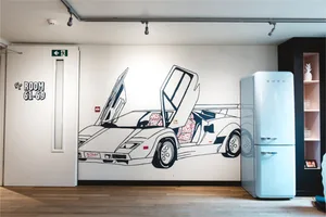 A wall mural depicting a sports car with a light blue refrigerator in the foreground.