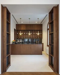 Modern kitchen with wooden cabinets and marble countertops.