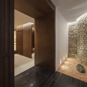 Modern living room featuring wooden elements and a stone garden.