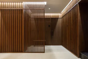 Modern minimalist lobby interior with polished wooden paneling and minimalist design.