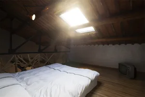 An industrial-style bedroom with wooden walls and a slanted wooden ceiling.