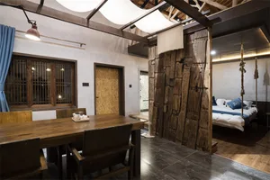 Industrial-themed dining room with wooden furniture and rustic decor.