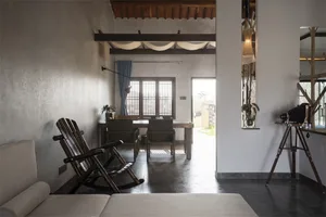 A minimalist living room with wooden elements and a cozy seating area.