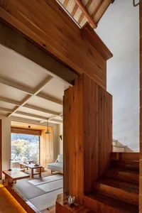 A modern minimalist residential interior with wooden elements.