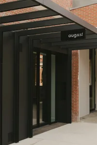 Modern building facade with black glass panels and red brick walls