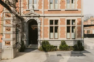 A modern building with a brick exterior and stone accents.