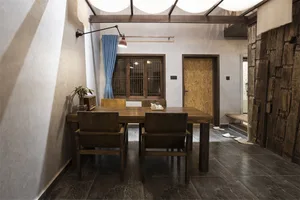 A well-designed dining room with wooden furniture and blue curtains.