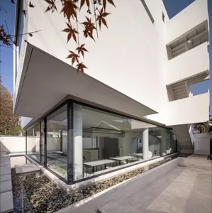 A modern house with a glass interior and outdoor space.