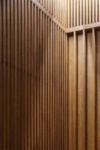 Vertical wood paneling with horizontal accents in a modern interior design setting.