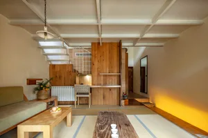 A modern living space featuring wooden tables and minimalist design elements.