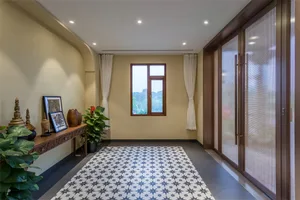 A modern living room featuring a tile floor with a star pattern, a window with white curtains, a wooden console table with sc