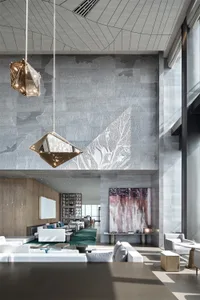Modern lounge area with concrete walls, bamboo furniture, and geometric lighting fixtures.
