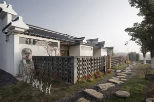 Modern residential building with brick and stone exterior featuring a traditional Chinese design.