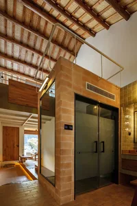 Modern residential interior featuring brick, concrete, and tiled walls and floors.