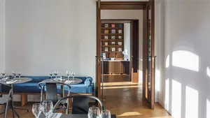 Interior view of a modern restaurant featuring wooden flooring and contemporary furniture.