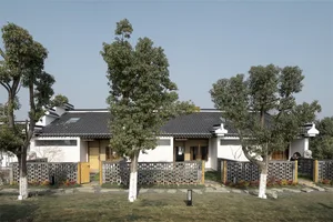 Traditional white residential architecture with wooden and stone elements.