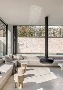 Modern living room with concrete furniture and minimalist design.