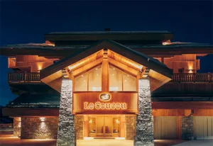 Modern architectural entrance made of wood at night.
