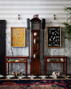 Marble floor adorned with decorative objects such as a grandfather clock, framed artwork, and glass tables.
