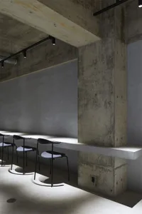 Modernist industrial commercial interior space with concrete walls and minimalist design.