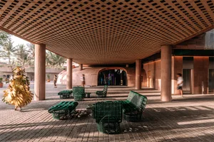 Industrial-style interior space featuring a wooden seat under a lattice ceiling.