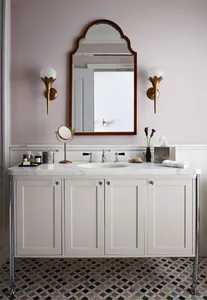 A modern bathroom with a marble countertop, concrete cabinets, and a sink cabinet space.